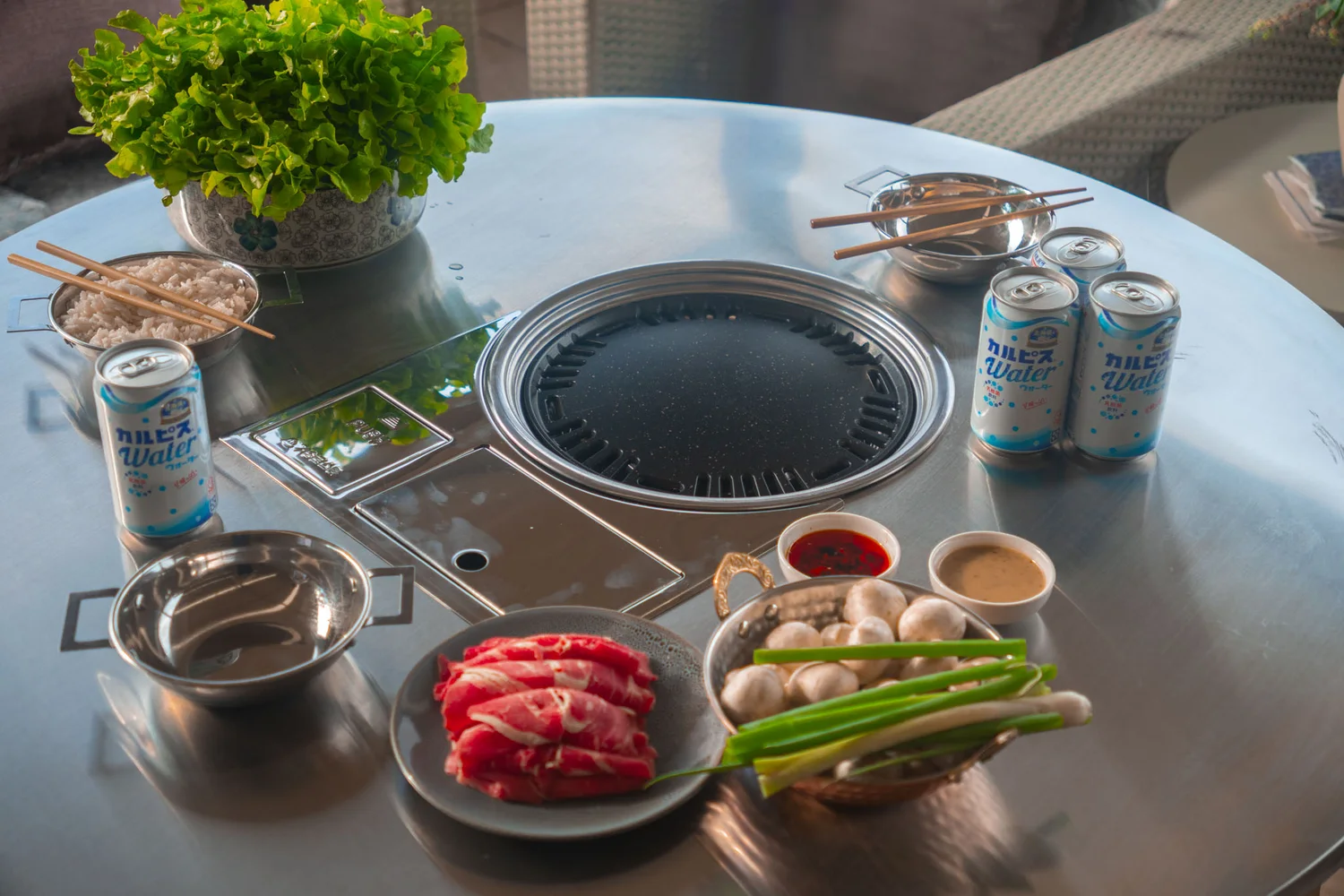 The Gachi Grill table set with beef, greens and drinks from above